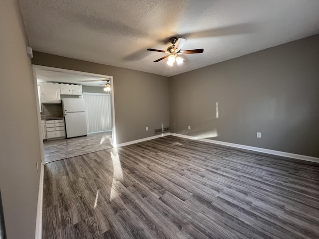 spare room featuring hardwood / wood-style floors, a textured ceiling, and ceiling fan