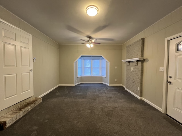 unfurnished room with dark carpet and ceiling fan