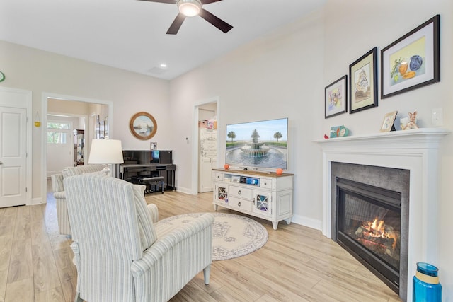5078 Song Sparrow Way, Summerville, SC 29483 - living room with a glass covered fireplace, ceiling fan, and light wood-type flooring