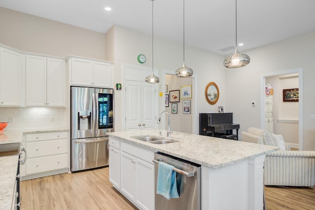 5078 Song Sparrow Way, Summerville, SC 29483 - kitchen with appliances with stainless steel finishes, a sink, light wood-style floors, tasteful backsplash, and white cabinets