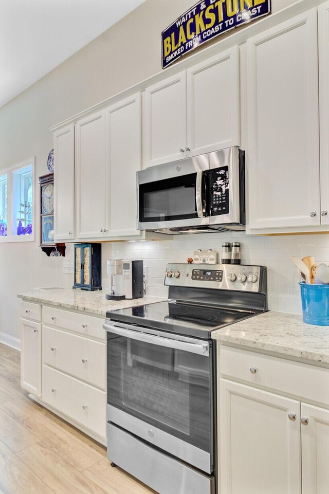 5078 Song Sparrow Way, Summerville, SC 29483 - kitchen featuring stainless steel appliances, decorative backsplash, white cabinetry, and light stone countertops