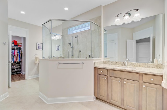 5078 Song Sparrow Way, Summerville, SC 29483 - bathroom featuring a stall shower, a walk in closet, vanity, baseboards, and recessed lighting
