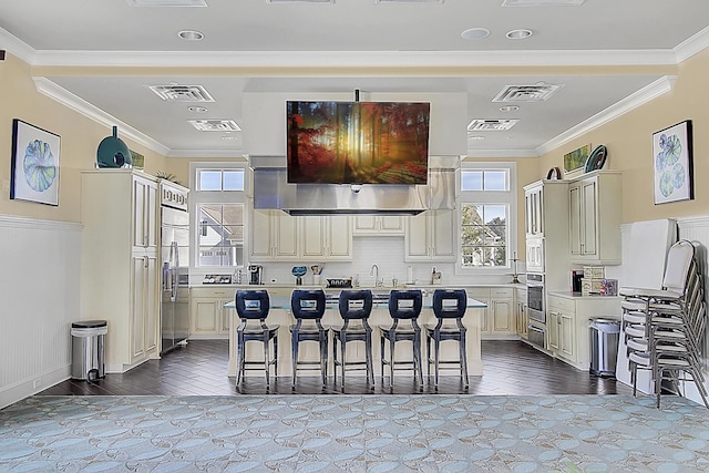 5078 Song Sparrow Way, Summerville, SC 29483 - kitchen with appliances with stainless steel finishes, light countertops, a breakfast bar area, plenty of natural light, and ornamental molding