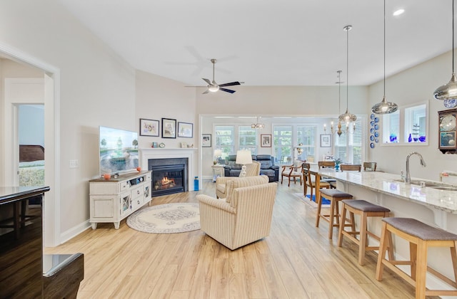 5078 Song Sparrow Way, Summerville, SC 29483 - living area featuring a glass covered fireplace, light wood-type flooring, ceiling fan, and baseboards