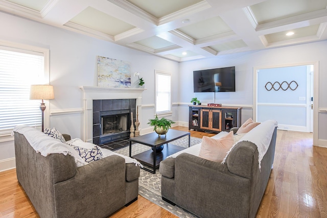 living area featuring beam ceiling, baseboards, coffered ceiling, and wood finished floors