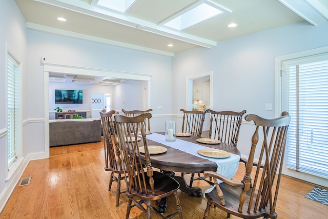 dining area with recessed lighting, beamed ceiling, light wood finished floors, and visible vents
