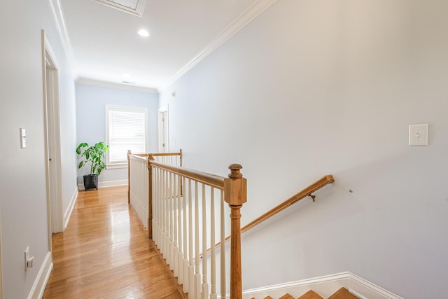 hall with an upstairs landing, recessed lighting, ornamental molding, baseboards, and light wood-style flooring