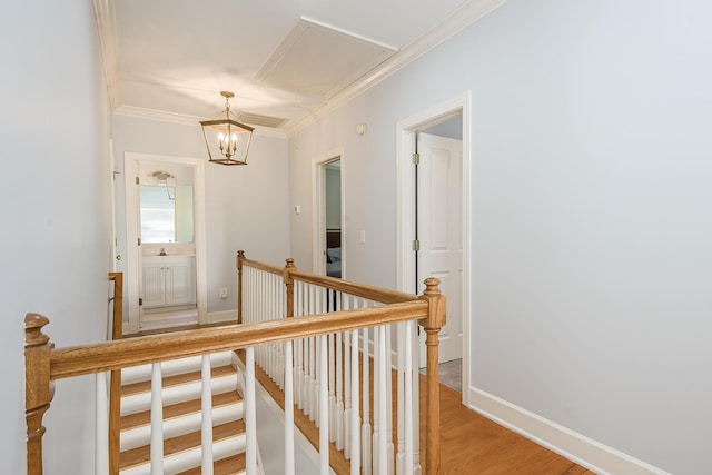 staircase featuring ornamental molding, baseboards, a chandelier, and wood finished floors