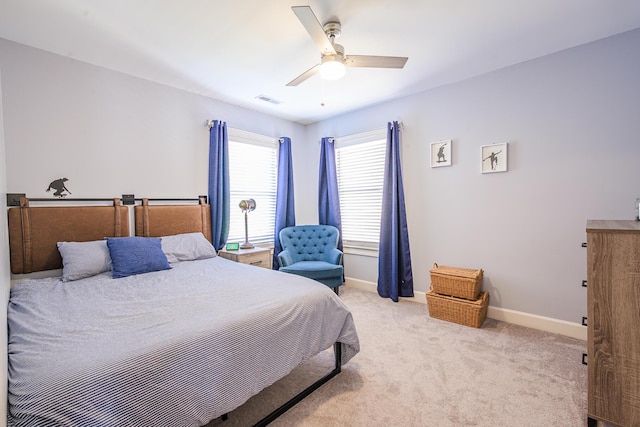 bedroom featuring carpet floors, baseboards, visible vents, and ceiling fan