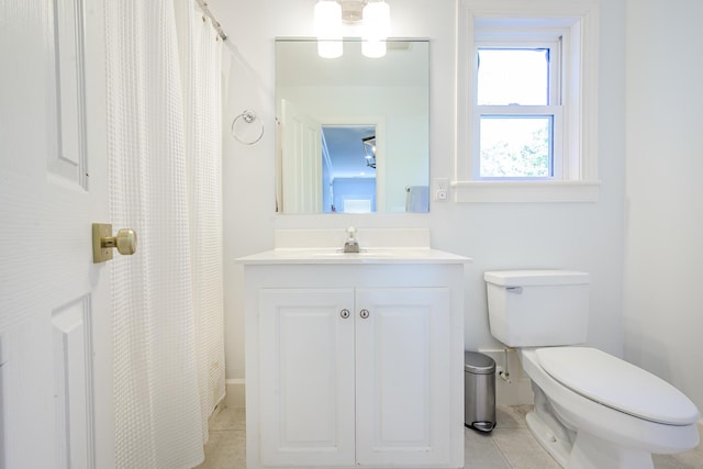 bathroom featuring toilet, vanity, and tile patterned flooring