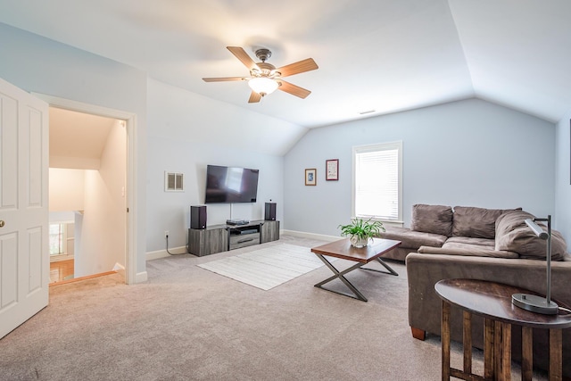 carpeted living room with baseboards, lofted ceiling, visible vents, and a ceiling fan