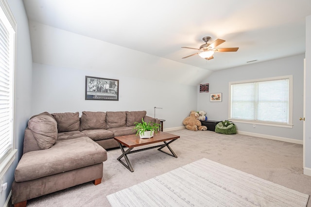 living area featuring visible vents, baseboards, ceiling fan, carpet floors, and vaulted ceiling