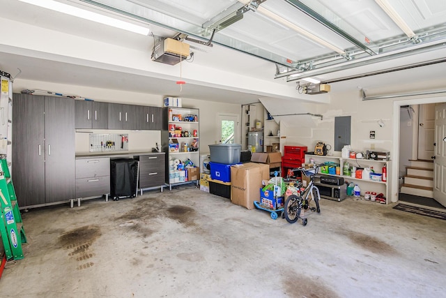 garage featuring electric panel and a garage door opener