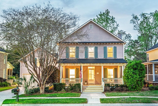 view of front of home with a chimney and covered porch