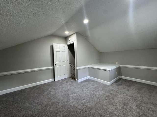106 Pelican St, Ladson, SC 29456 - additional living space with baseboards, dark colored carpet, a textured ceiling, and vaulted ceiling