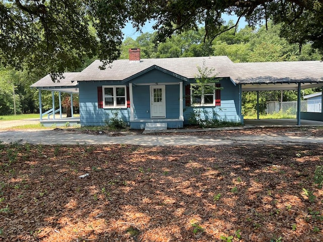 view of front of property featuring a porch and a carport