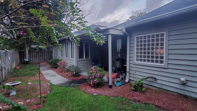 view of side of property featuring fence