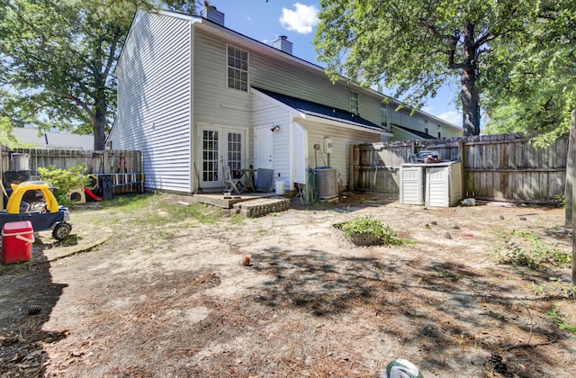 4662 Nibbs Ln, North Charleston, SC 29418 - back of house with a chimney, french doors, a fenced backyard, and central air condition unit