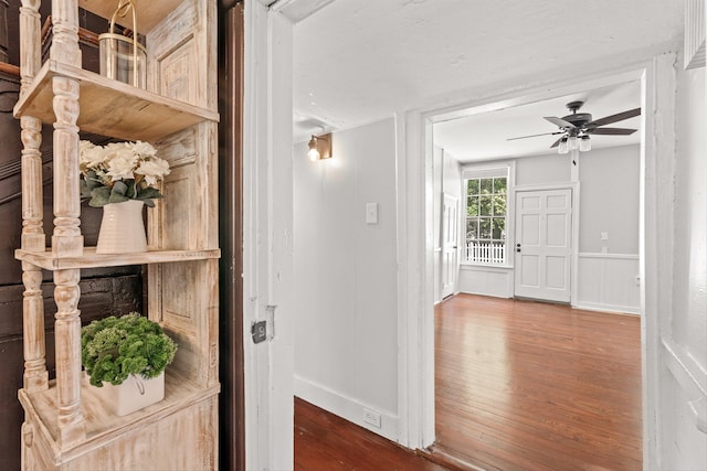 corridor with hardwood / wood-style floors