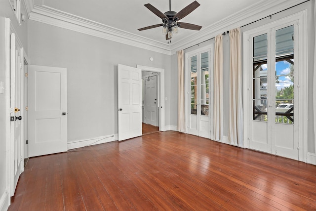 empty room featuring ornamental molding, dark hardwood / wood-style floors, and ceiling fan