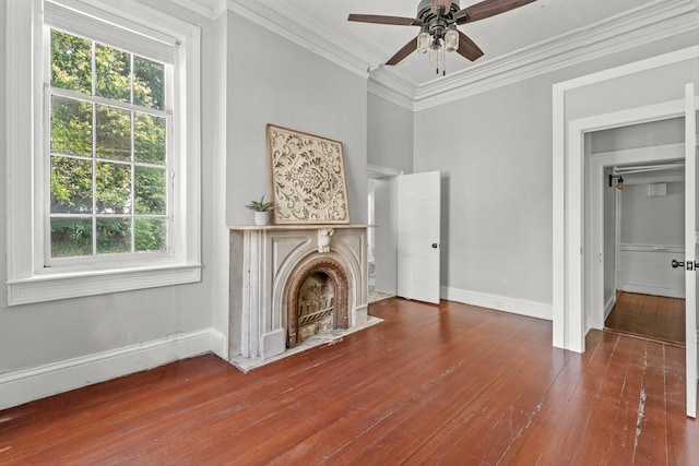 unfurnished living room featuring hardwood / wood-style floors, ceiling fan, and crown molding