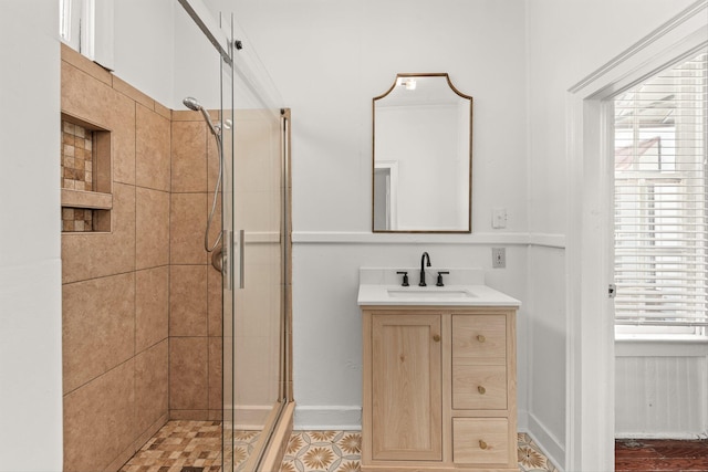 bathroom with a wealth of natural light, vanity, and a shower with shower door