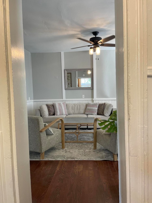 living room featuring dark hardwood / wood-style flooring and ceiling fan