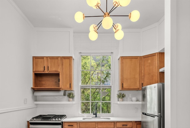 kitchen featuring pendant lighting, sink, backsplash, and stainless steel appliances