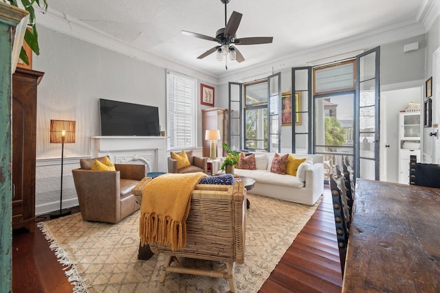 living room featuring ceiling fan, hardwood / wood-style flooring, and ornamental molding