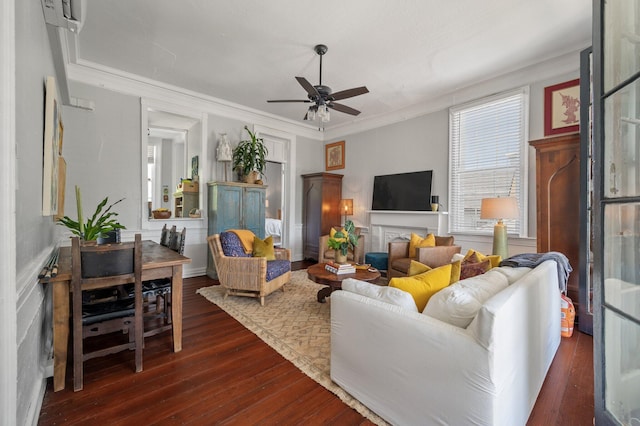 living room with dark hardwood / wood-style flooring, ceiling fan, a wall mounted air conditioner, and ornamental molding