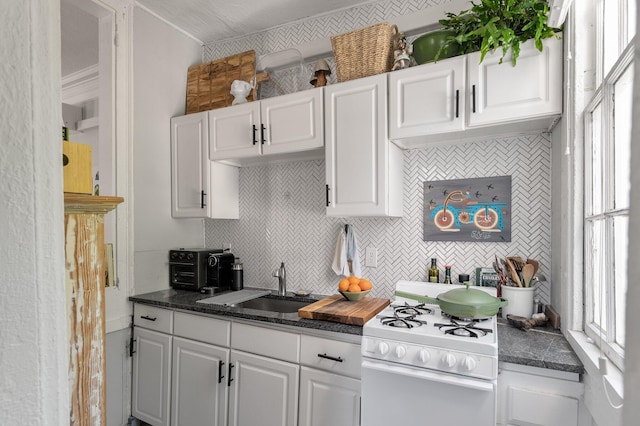 kitchen with white cabinets, a textured ceiling, sink, and white range oven