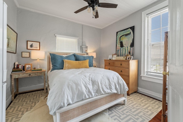 bedroom featuring light hardwood / wood-style floors, ceiling fan, and ornamental molding