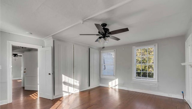 interior space with dark wood-type flooring and ceiling fan