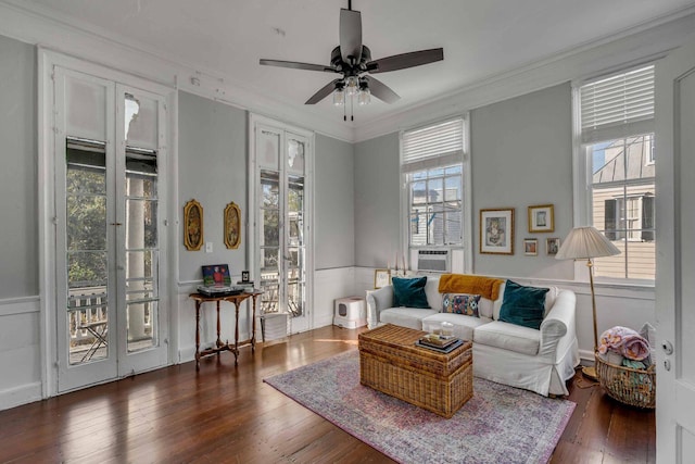 living room featuring ornamental molding, plenty of natural light, dark wood-type flooring, and ceiling fan