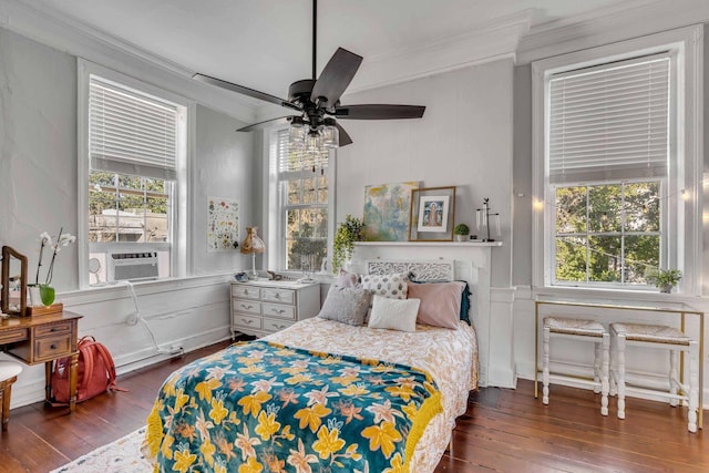 bedroom with dark wood-type flooring, ceiling fan, cooling unit, and crown molding