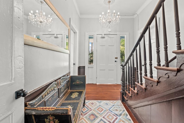 foyer entrance featuring an inviting chandelier, hardwood / wood-style floors, and ornamental molding