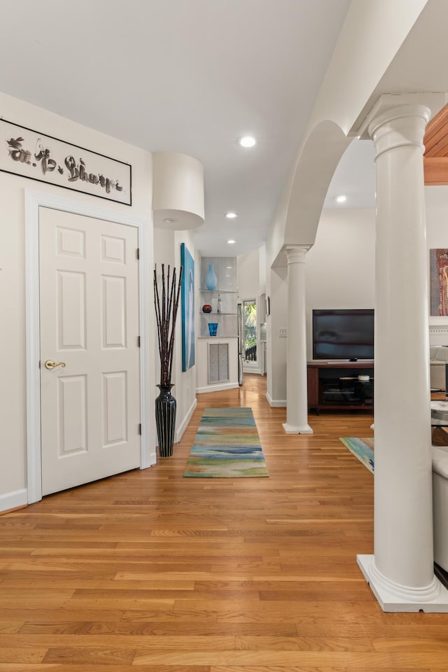 2105 Loblolly Ln, Seabrook Island, SC 29455 - foyer entrance with decorative columns, light wood-type flooring, recessed lighting, arched walkways, and baseboards