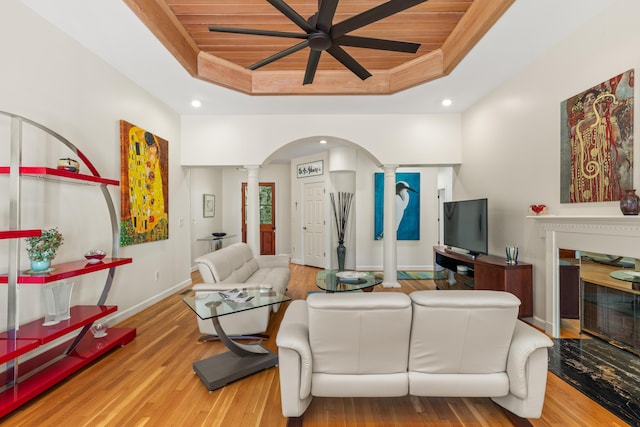 2105 Loblolly Ln, Seabrook Island, SC 29455 - living room with ornate columns, a raised ceiling, wooden ceiling, baseboards, and wood finished floors
