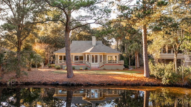 2105 Loblolly Ln, Seabrook Island, SC 29455 - rear view of property featuring a chimney, roof with shingles, and a wooden deck