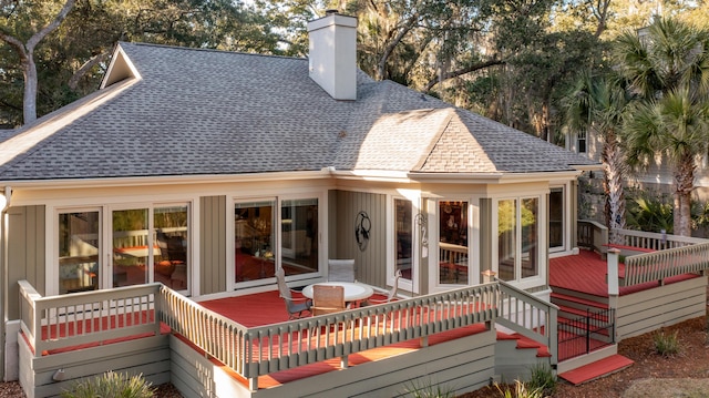 2105 Loblolly Ln, Seabrook Island, SC 29455 - rear view of house featuring roof with shingles, a wooden deck, a chimney, and board and batten siding