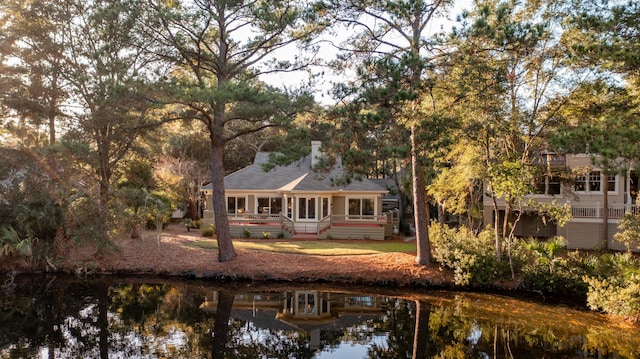 2105 Loblolly Ln, Seabrook Island, SC 29455 - rear view of property with a sunroom and a chimney