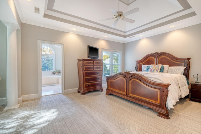 bedroom with a tray ceiling, multiple windows, and ceiling fan