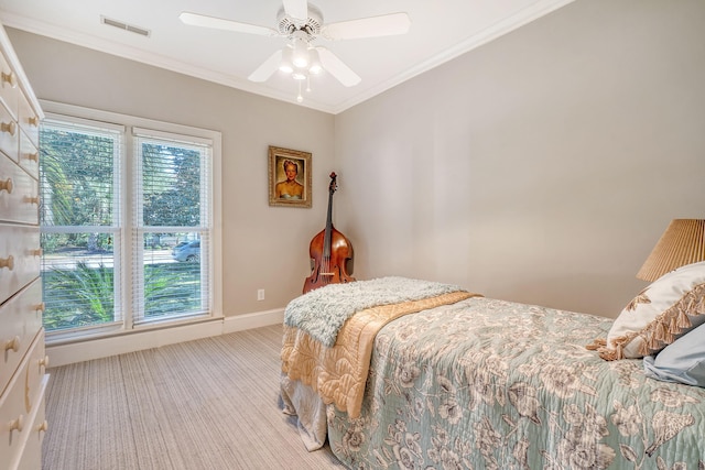 bedroom with light carpet, ceiling fan, and ornamental molding