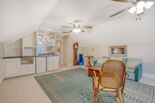 carpeted dining area with ceiling fan, sink, and vaulted ceiling