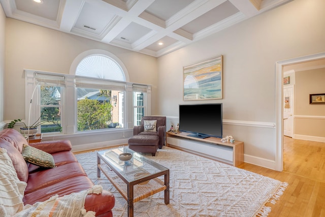 living room featuring beam ceiling, light hardwood / wood-style flooring, ornamental molding, and coffered ceiling