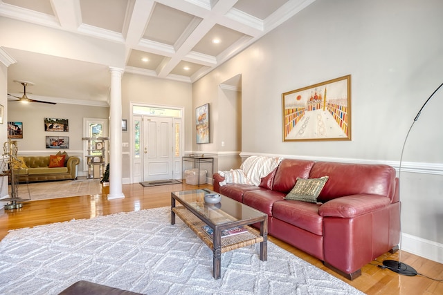 living room featuring ornate columns, ceiling fan, wood-type flooring, and coffered ceiling