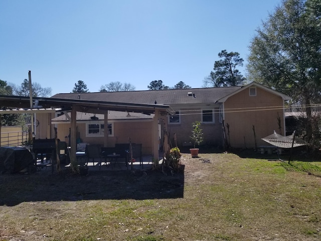 back of house featuring a patio area, a lawn, and outdoor lounge area