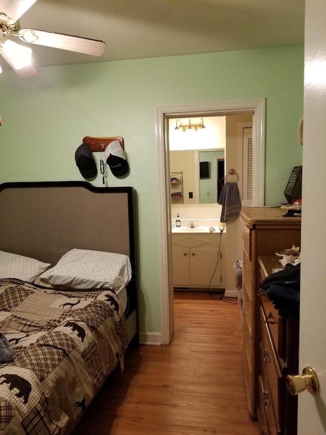 bedroom with ceiling fan, sink, ensuite bathroom, and light hardwood / wood-style floors