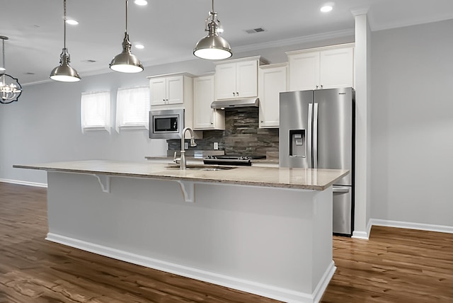 kitchen with decorative light fixtures, sink, white cabinetry, and stainless steel appliances