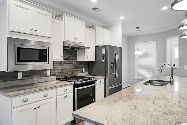 kitchen featuring white cabinets, crown molding, sink, appliances with stainless steel finishes, and decorative light fixtures